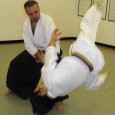 The most efficient energy transfer for Aikido techniques occurs if centers are close.  "Close enough to kiss" is a way to check your distance and, perhaps, remember this concept.
